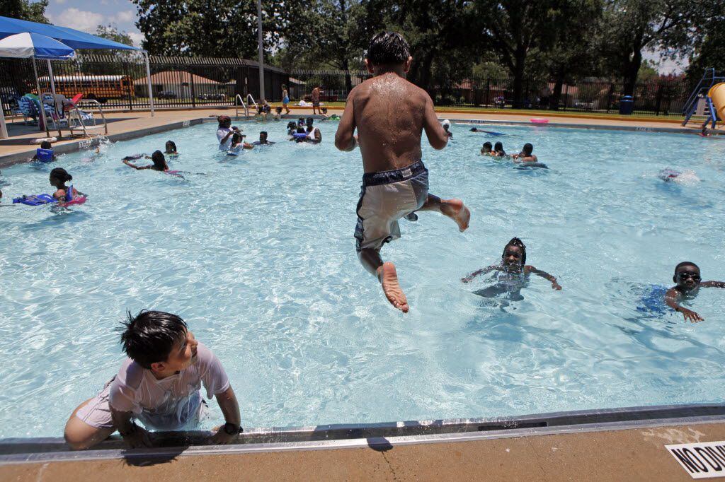 Eduardo Barbosa Mijares, 9, leaps into the swimming pool at Pleasant Oaks Swimming Pool, on...