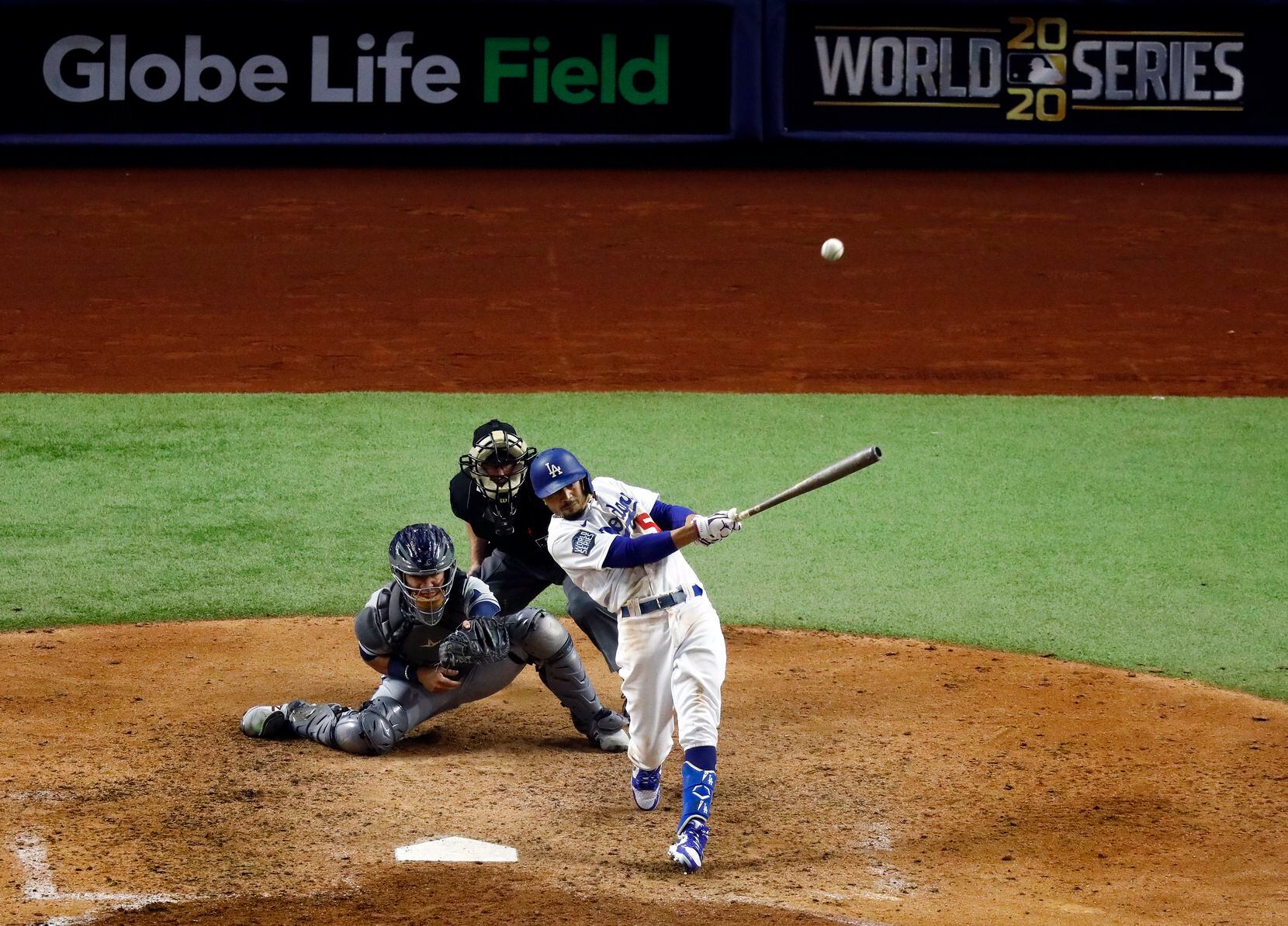 Los Angeles Dodgers right fielder Mookie Betts (50) hits a solo home run against the Tampa...