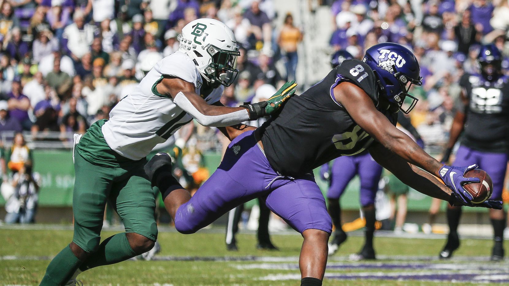 TCU Horned Frogs tight end Pro Wells (81) receives a pass as Baylor Bears cornerback Kalon Barnes (12) defends during the first half of an NCAA football matchup between the Texas Christian University Horned Frogs and the Baylor Bears at Amon G. Carter Stadium in Fort Worth, Texas, on Saturday, No. 9, 2019.