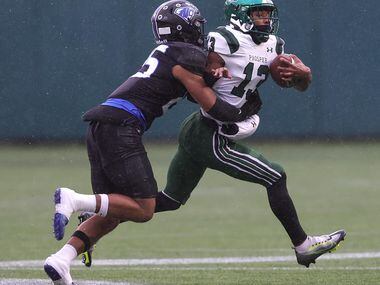 Prosper wide receiver Prentice Sanders (13) tries to break away from North Crowley safety...