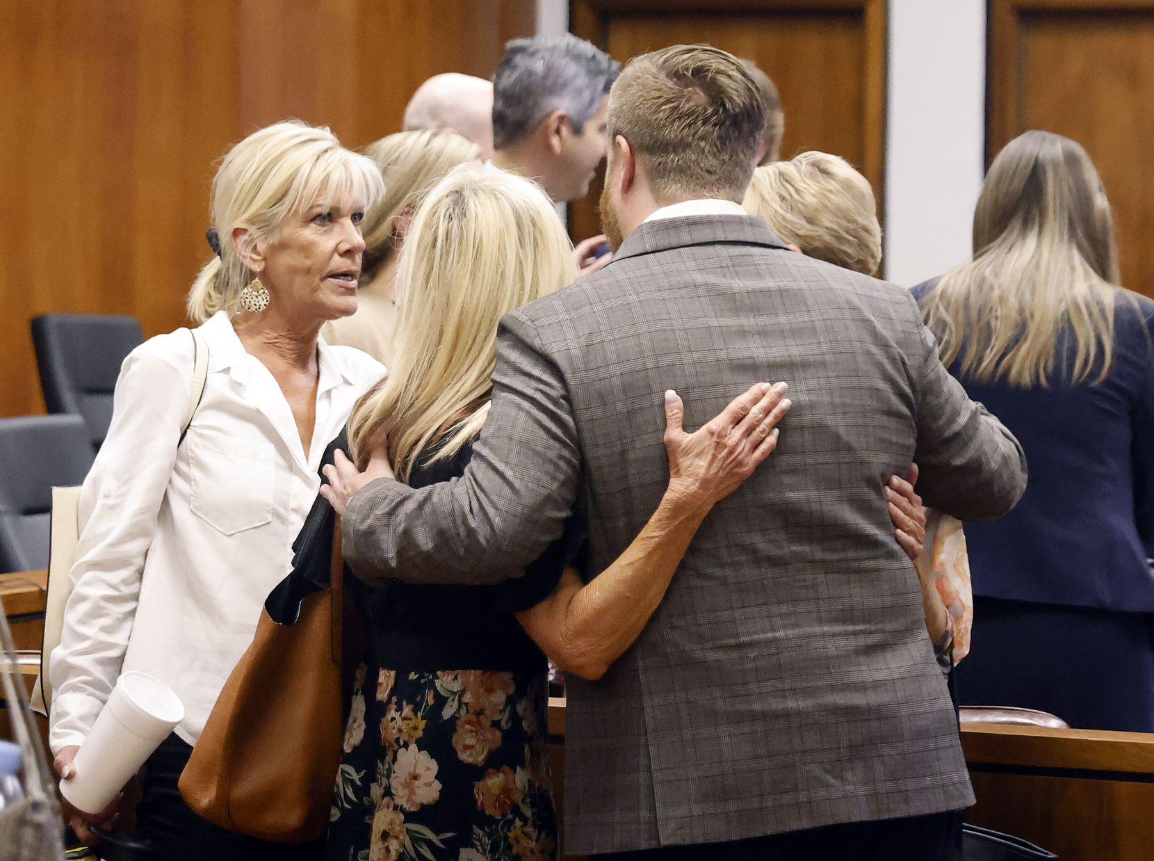 Attorney Paul Wingo hugs Betty Thomas’ daughters (from left) Cheryl Goff, Charlotte Glover,...