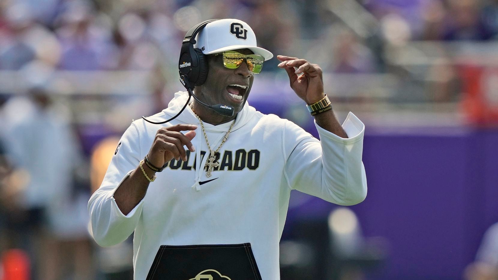 Colorado head coach Deion Sanders yells from the sidelines during the first half of an NCAA...