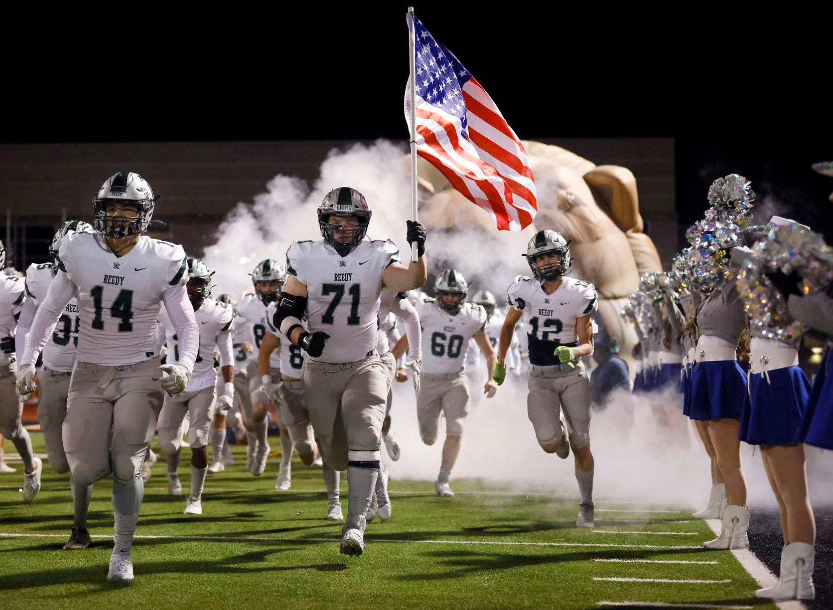 The Frisco Reedy football team runs onto the field to face Lancaster in their Class 5A...