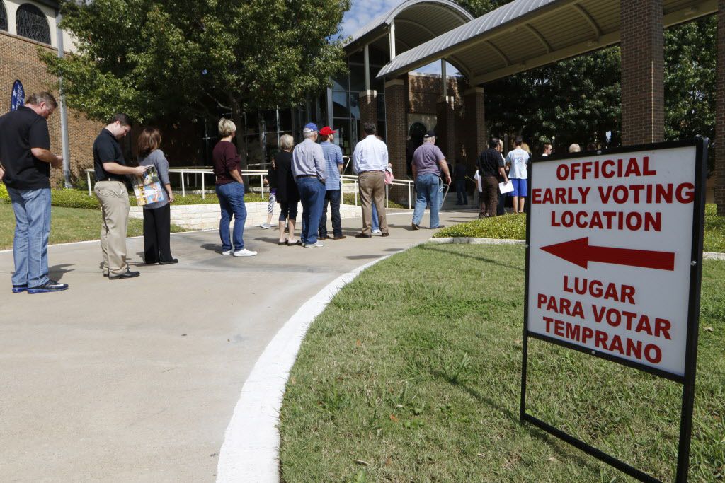 Voters wait to cast ballots early at Our Redeemer Lutheran Church in Dallas on Monday. Today...