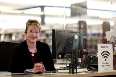 Librarian Kelly Moore poses at the Josey Ranch Lake Carrolton Public Library in Carrollton,...