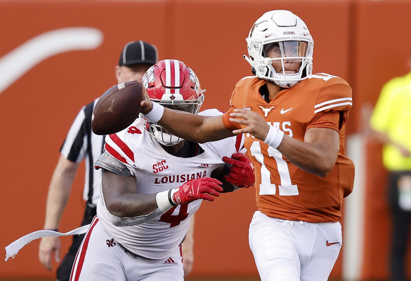 Texas Longhorns quarterback Casey Thompson (11) escapes the pass rush of Louisiana-Lafayette Ragin Cajuns defensive lineman Zi'Yon Hill (4) during the fourth quarter at DKR-Texas Memorial Stadium in Austin, Saturday, September 4, 2021. (Tom Fox/The Dallas Morning News)