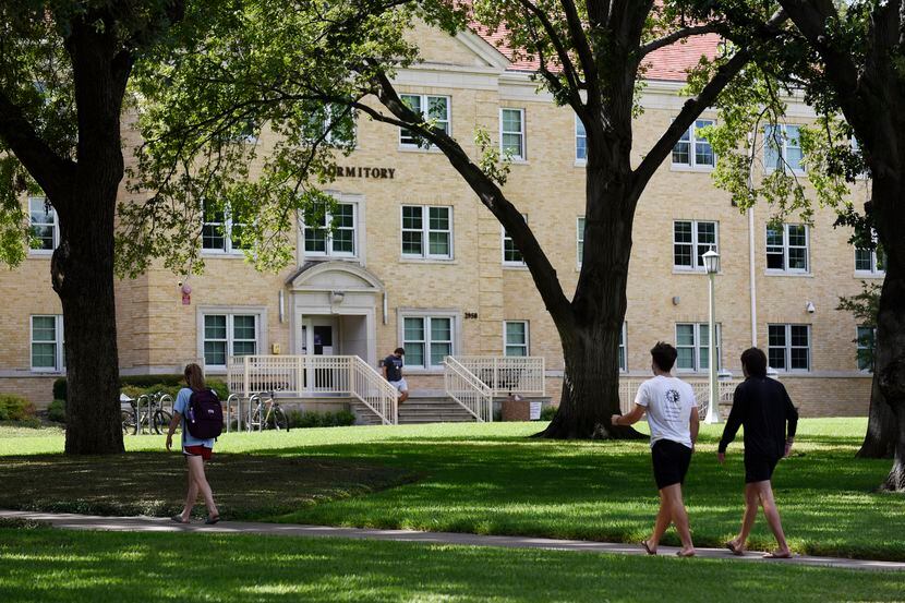 Texas Christian University students walk toward the Clark Hall dormitory on the campus of...