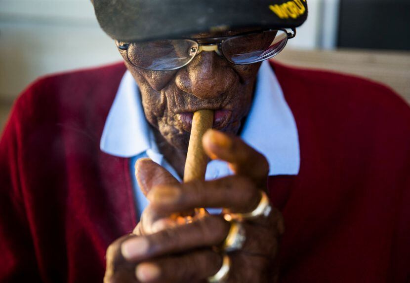Richard Overton, 111, lights up a cigar on his front porch on May 25 on Richard Overton...