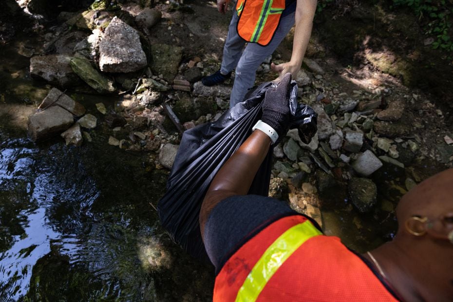 Volunteers Cynthia Smoot and Angelita Howard collect trash at Dallas Zoo's Wild Earth Action...