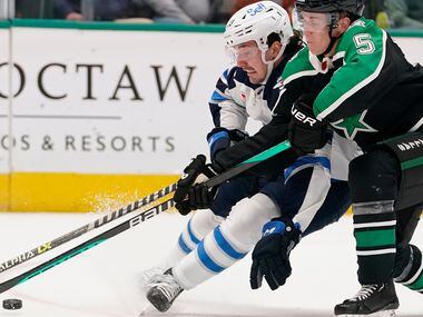 Winnipeg Jets center Michael Eyssimont (23) skates with the puck against Dallas Stars...