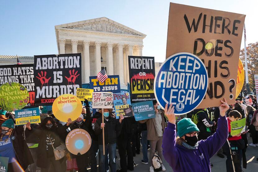 Demonstrators gather at the U.S. Supreme Court as the justices hear arguments in Dobbs v....