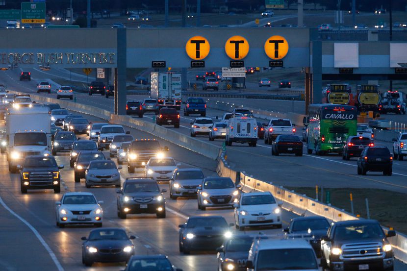Cars pass through the automated NTTA toll station on the Bush Turnpike during rush hour in...