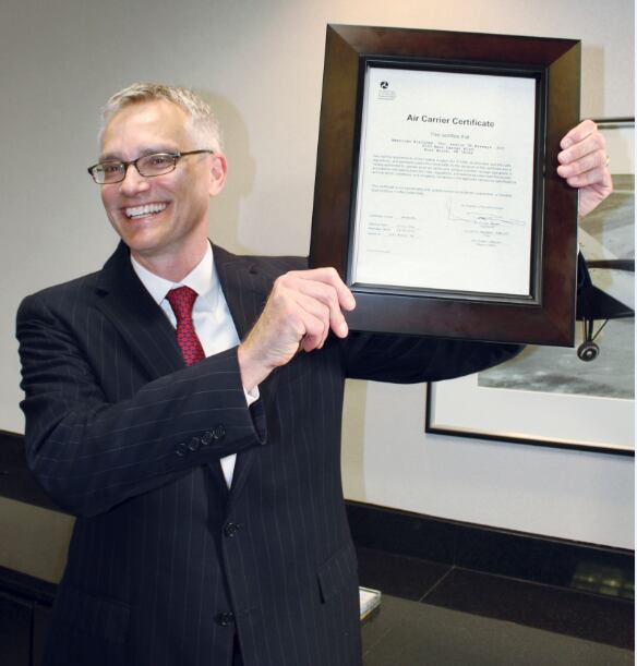 When he was American Airlines' chief operating officer, Robert Isom showed off the single operating certificate for American and US Airways after the merger between the two airlines.