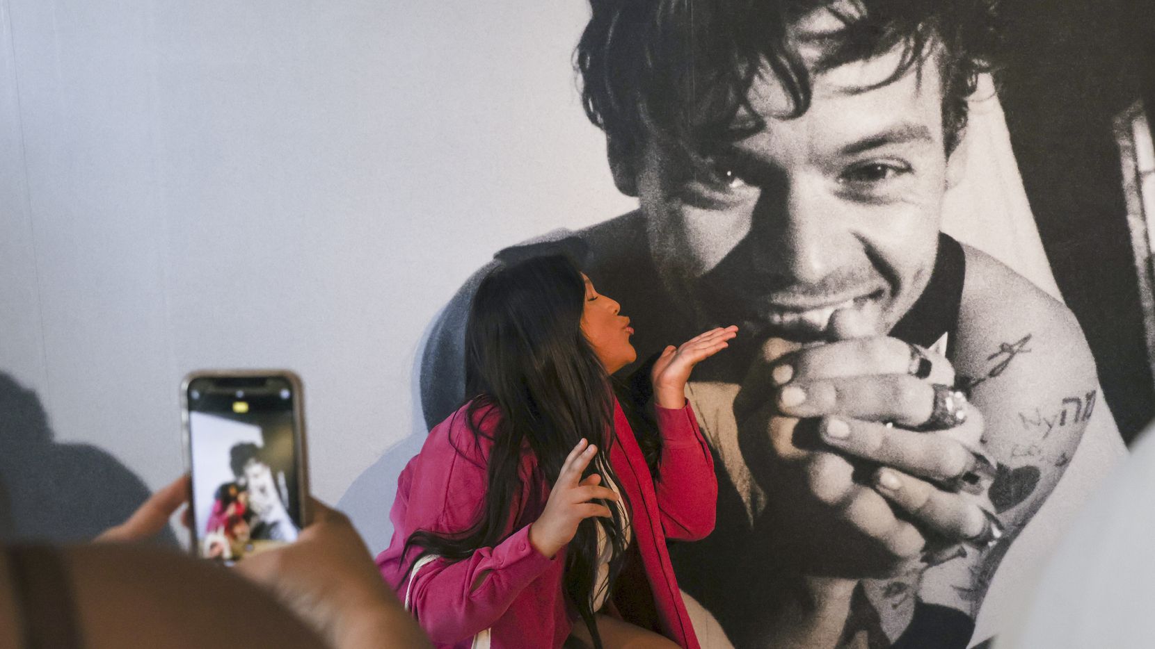 Itzel Ramirez blows a kiss to a photo of Harry Styles on Friday at the Harry’s House pop-up...