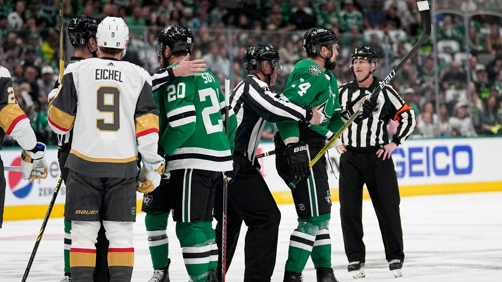 Dallas Stars left wing Jamie Benn, right, is escorted by officials as Vegas Golden Knights'...