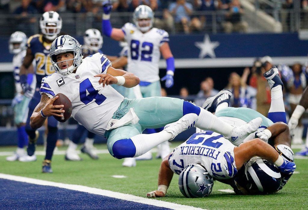 Dallas Cowboys quarterback Dak Prescott (4) scores a two-point conversion but the score was...