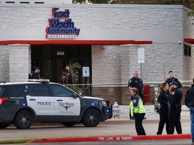 Fort Worth Police officers secure the scene outside the Fort Worth Community Credit Union on...