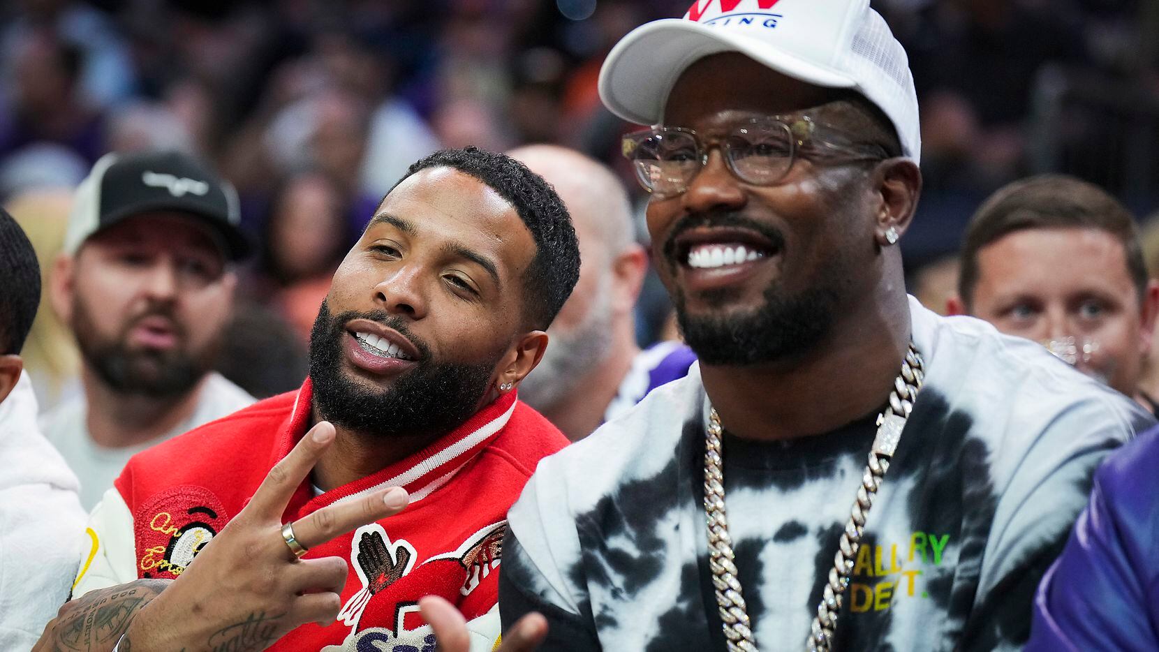 NFL players Von Miller (right) and Odell Beckham Jr. pose for a photo courtside during the...
