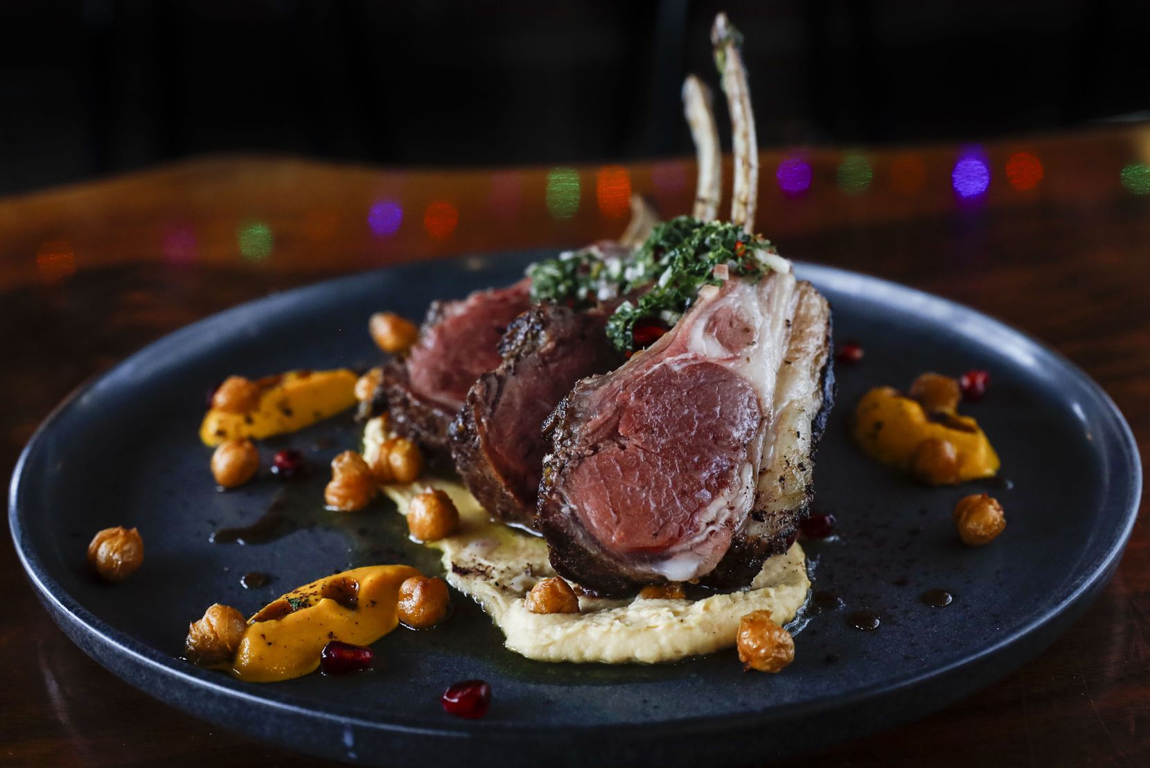 Elysian Fields rack of lamb is a part of Encina's Christmas dine-in special in Dallas. The dish includes chickpea puree, crispy chickpeas and mint-pomegranate salsa verde.