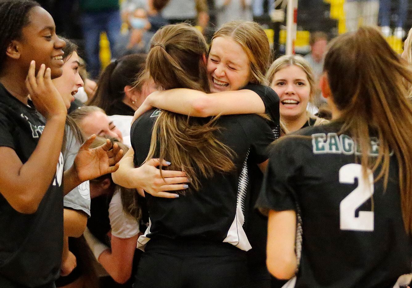 Prosper High School middle blocker Sydney Thornton (5) embraces Prosper High School setter Callie Kieffer (1) after they won the first round Class 6A playoff match against Flower Mound High School at The Colony High School on Tuesday, November 2, 2021. (Stewart F. House/Special Contributor)
