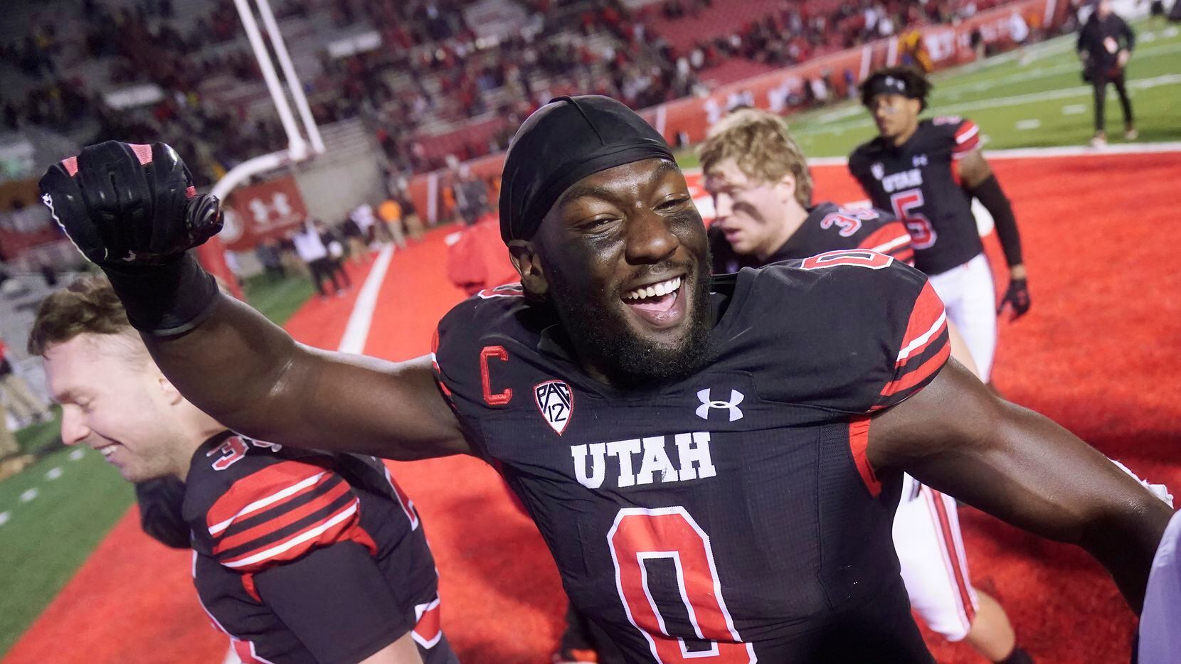 Utah linebacker Devin Lloyd (0) celebrates as he walks off the field following their NCAA...