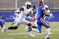 Duncanville’s Dakorien Moore (1) bobbled the snap on a third quarter punt and scrambled for...