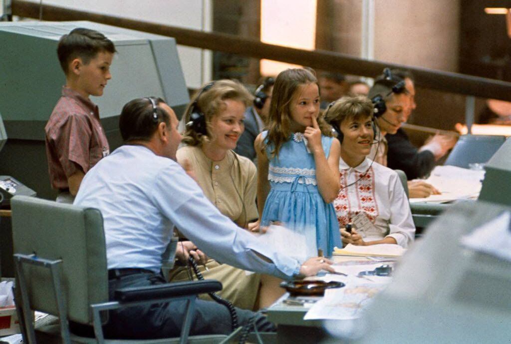 Astronauts' wives Pat White (right) and Pat McDivitt (left) and the Whites' children, Bonnie  and Eddie III, visit Mission Control and sit with flight director Chris Kraft, during Gemini 4 (during which  Ed White performed the first U.S. spacewalk), in June 1965.  NASA image provided by Grand Central Publishing.