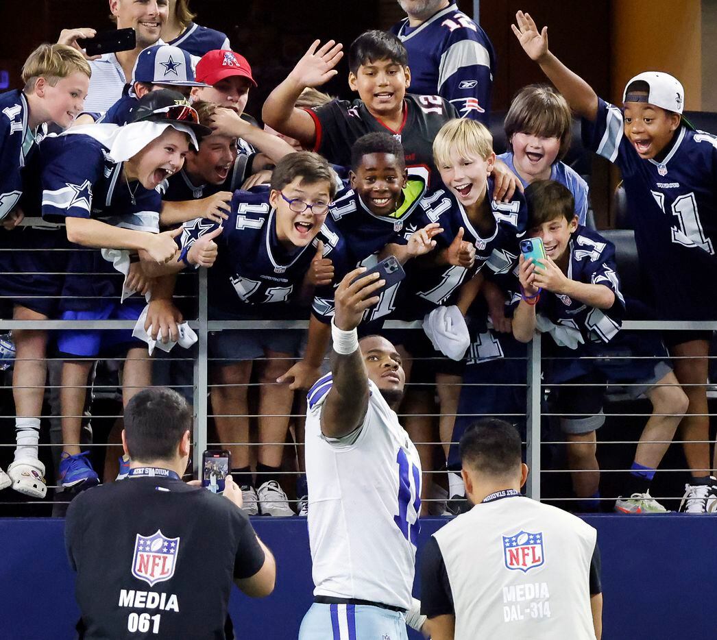 After the game, Dallas Cowboys linebacker Micah Parsons (11) took a selfie with young fans...