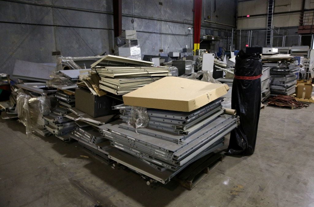 Stacks of unused cubicles sat in the warehouse at the Prestige Ameritech manufacturing plant...