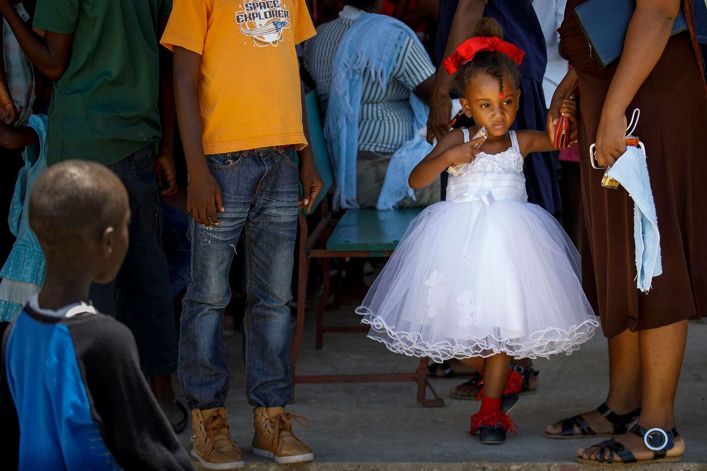 A young girl arrives for worship services at the LiveBeyond compound in Thomazeau, Haiti. 