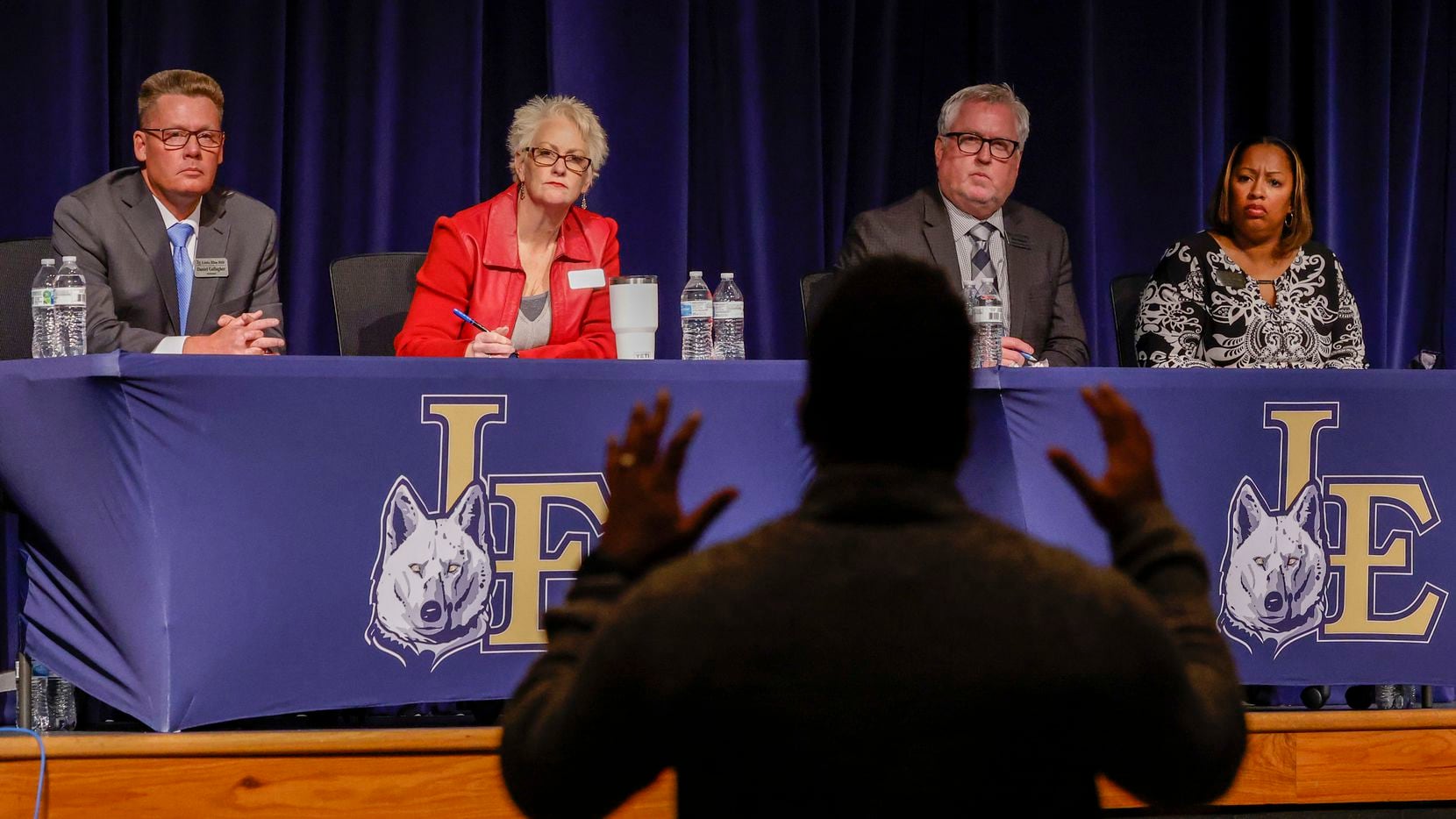 Little Elm ISD Superintendent Daniel Gallagher, far left, and other school officials listen to a parent during a listening session about the response to a student protest at the high school that led to teens being pepper sprayed and one being tased.