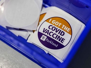 COVID vaccine stickers where the Pfizer-BioNTech COVID-19 vaccine is administered at Ellis Davis Fieldhouse, a testing and vaccination site at Parkland Hospital, in Dallas, on Wednesday, March 3, 2021 (Lola Gomez / The Dallas Morning News)