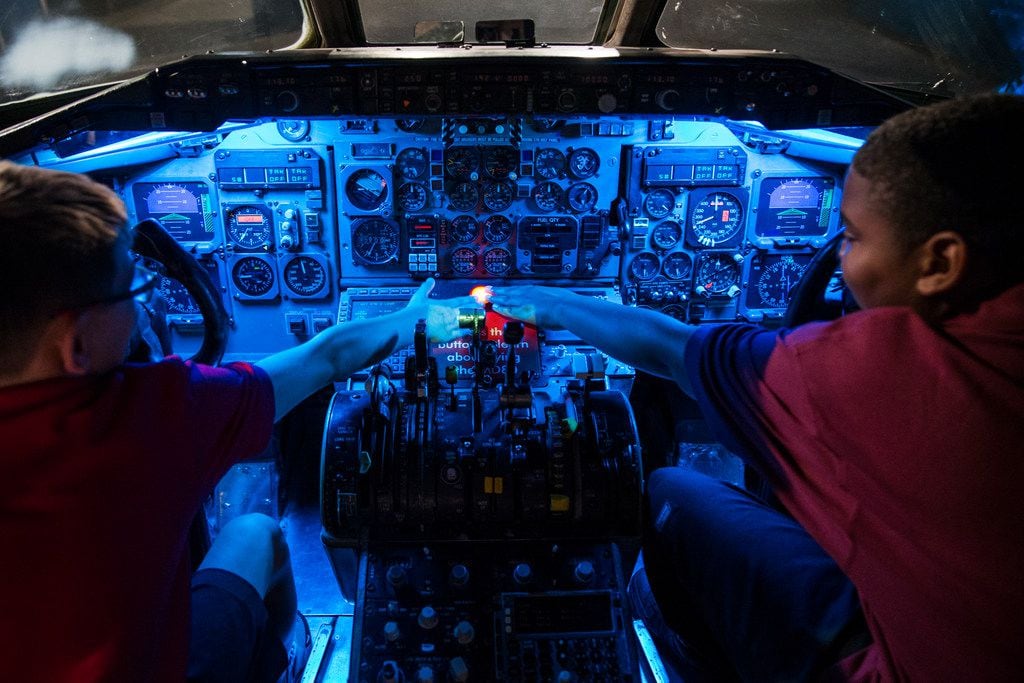 Andrew Sharp (left), 11, and Porter Hammons, 11, both sixth graders at Merryhill Elementary School in Arlington, Texas explore the cockpit of a McDonnell Douglas MD-80 during a tour of American Airlines C.R. Smith Museum on Thursday, August 23, 2018 in Fort Worth. The newly renovated museum reopens Labor Day Weekend. (Ryan Michalesko/The Dallas Morning News)
