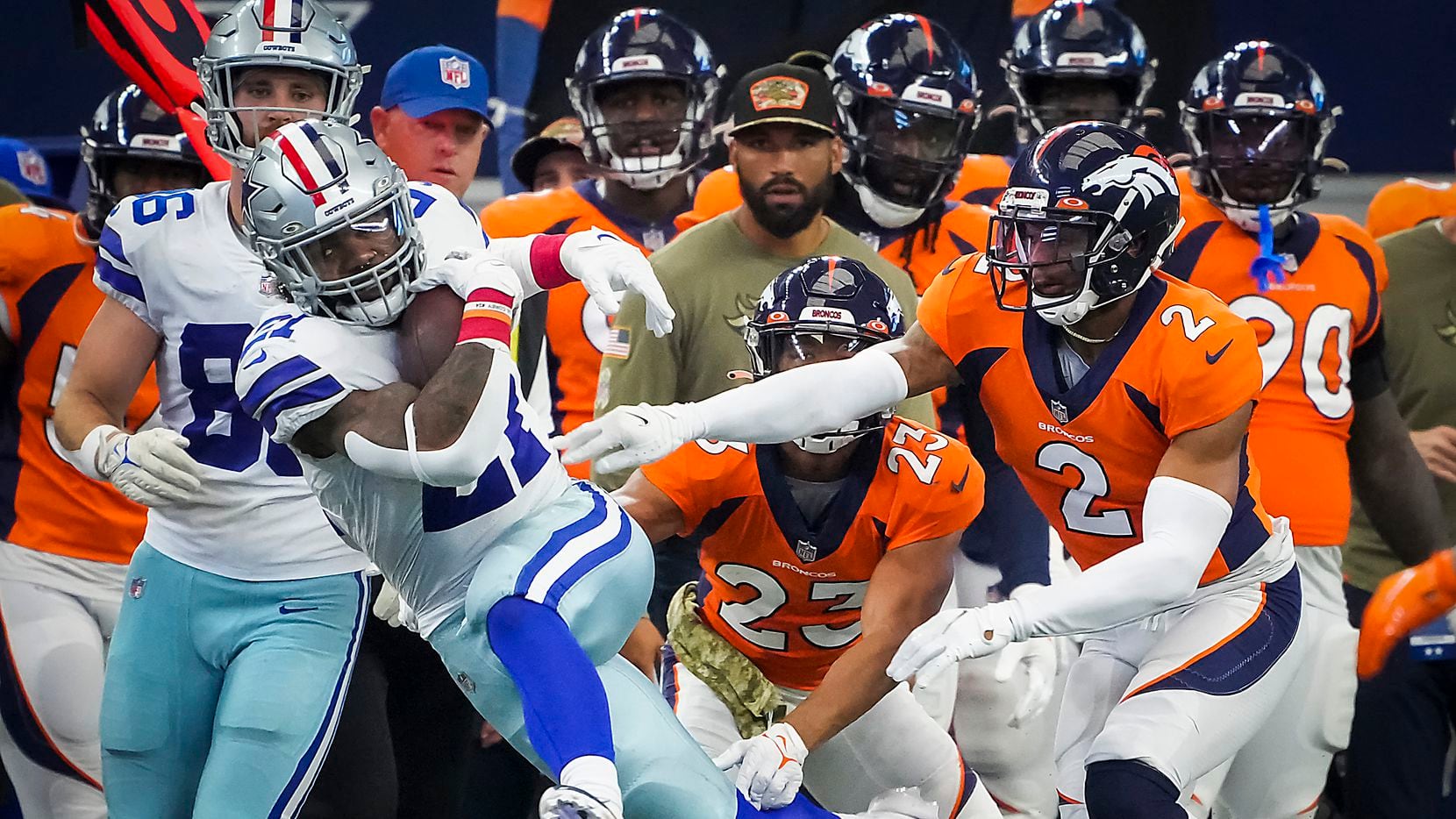 Dallas Cowboys running back Ezekiel Elliott (21) is knocked out of bounds by Denver Broncos...