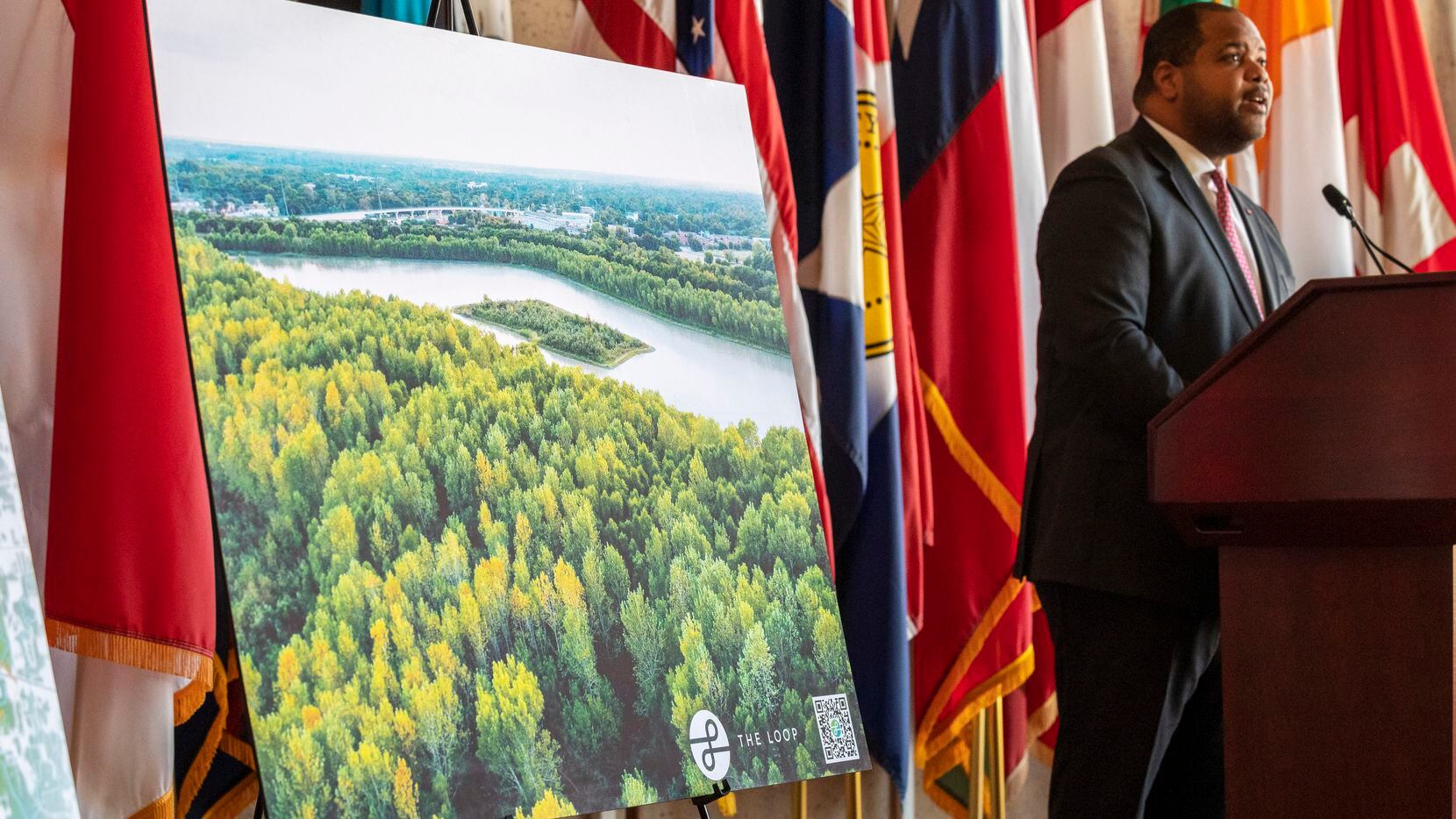 An image of Parkdale Lake is on display as Dallas Mayor Eric Johnson, right, announces a donation of 110 acres of land to the city's Park and Recreation department, including Parkdale Lake, by Oncor Electric Delivery, on Tuesday, Nov. 30, 2021 at City Hall in downtown Dallas.