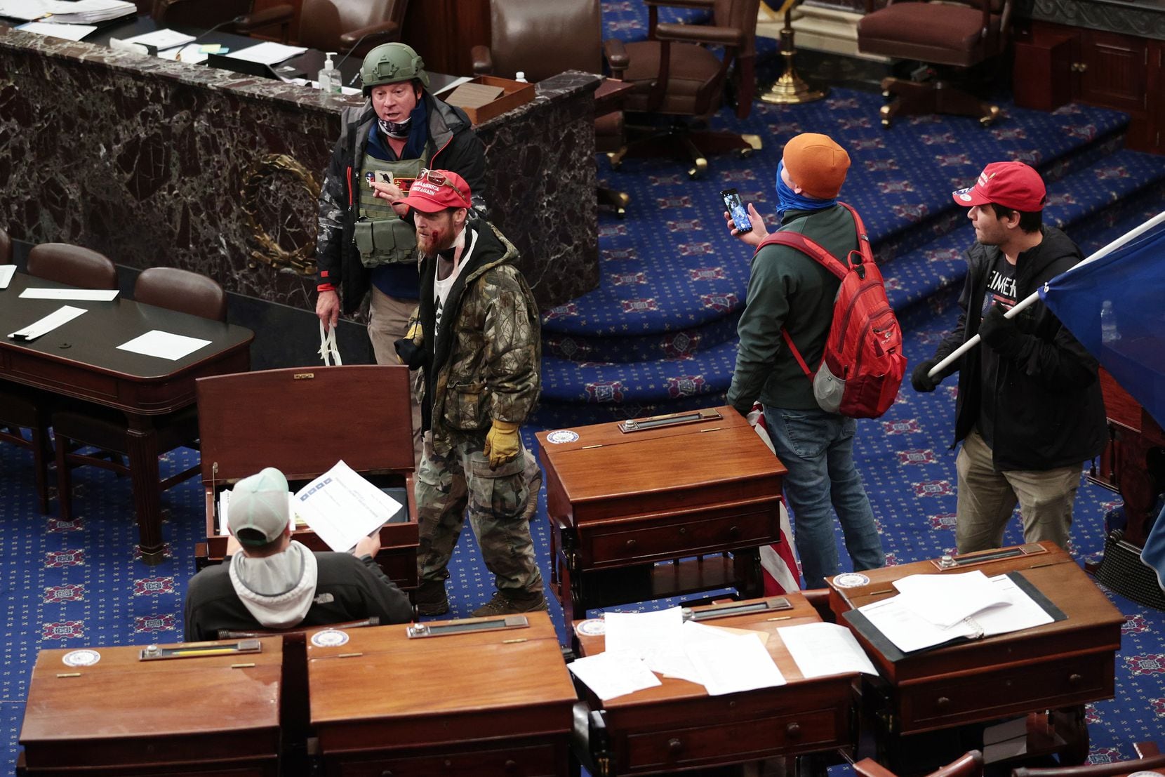Air Force veteran Larry Brock Jr. confirmed to The New Yorker magazine that this widely circulated image from Wednesday's shocking scene in the U.S. Senate chamber shows him in the upper left, wearing combat gear.