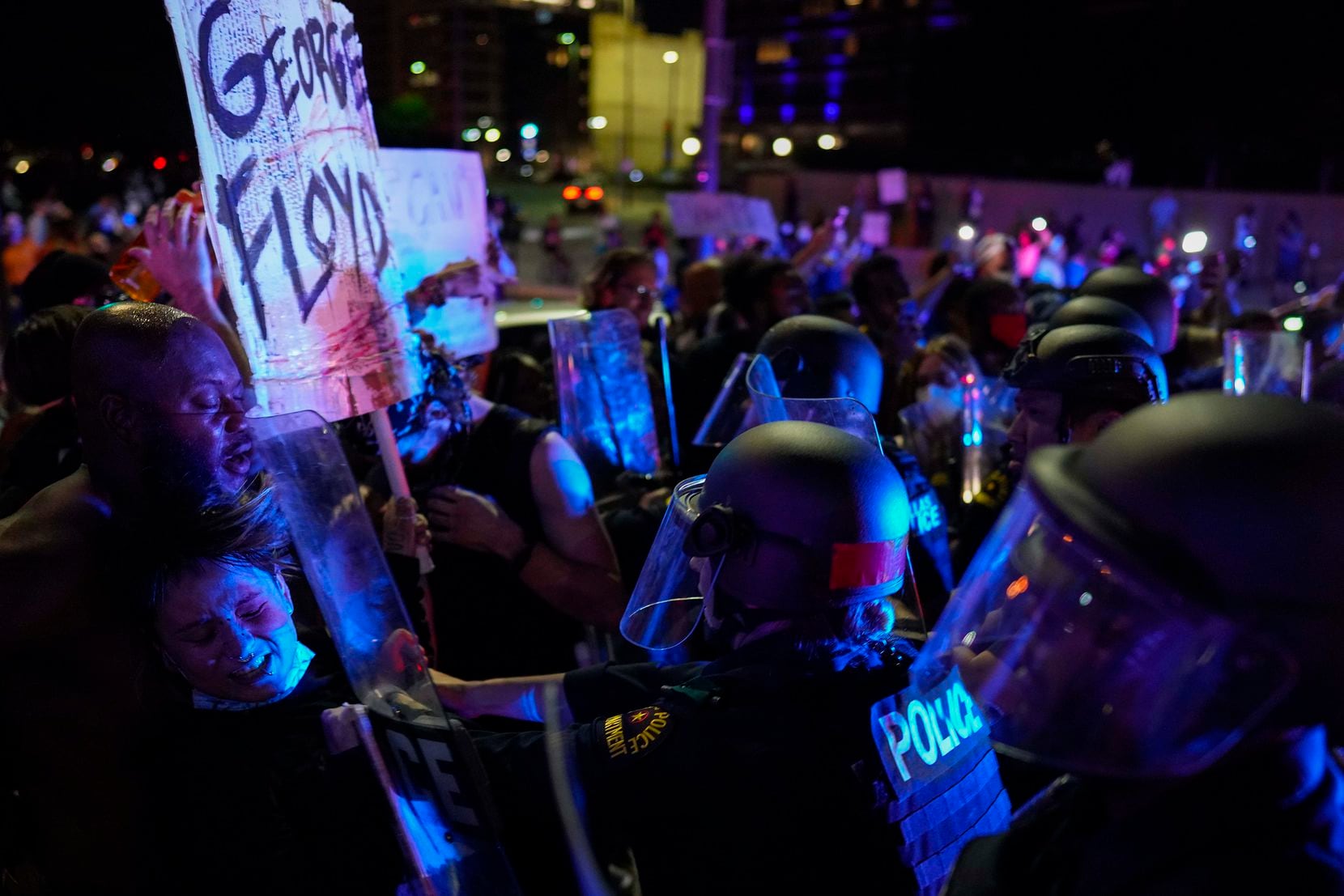 Dallas police clash with protesters at the corner of of Griffin and Young Streets as they...