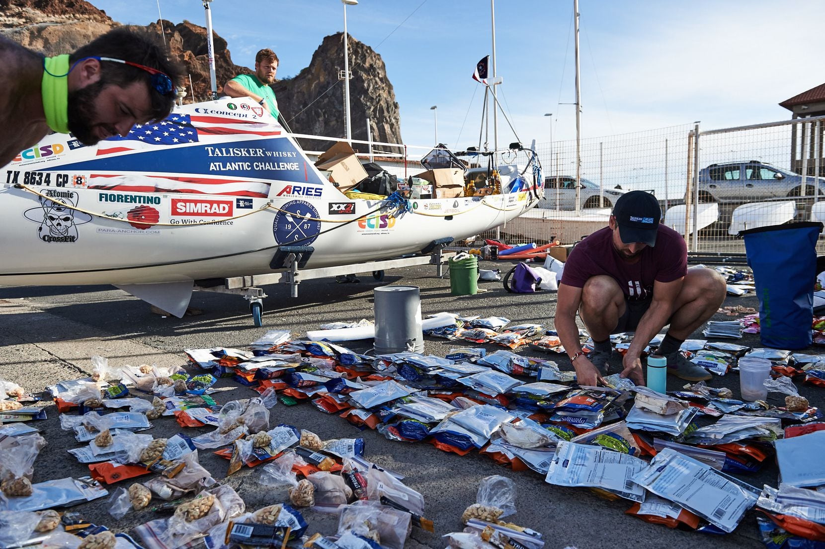 The American Oarsmen prepare their stock of meal rations before the start of the trip. From...