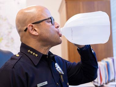Dallas police Chief Eddie García drinks his gallon of water in his office at Jack Evans Police Headquarters on Tuesday, Jan. 25, 2022, in Dallas, TX. 