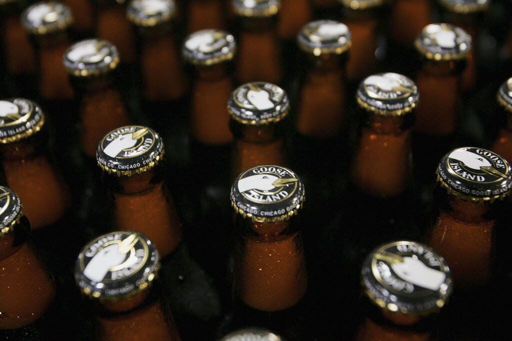Freshly bottled beer rolls down a conveyor to be labeled and packaged at the Goose Island...