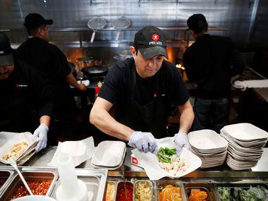 Gustavo Franco, wok cook, prepared a dish at Pei Wei in Irving on Feb. 7.