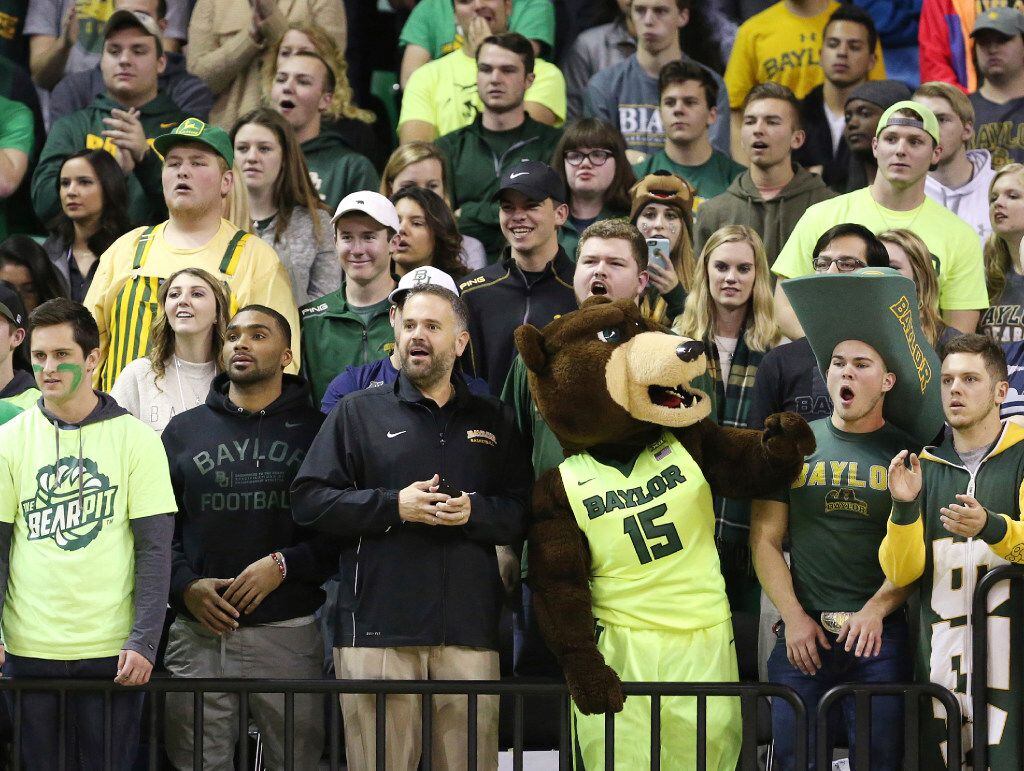 Baylor head football coach Matt Rhule, center, stands with students watching the team's NCAA...