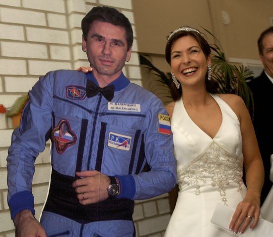 Ekaterina Dmitriev Malenchenko posed with a cardboard cutout of her new husband, cosmonaut Yuri Malenchenko, following a wedding ceremony via satellite link in August 2003.