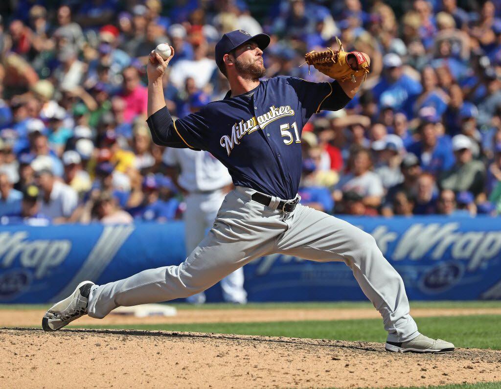 CHICAGO, IL - AUGUST 16:  Damien Magnifico #51 of the Milwaukee Brewers pitches against the...