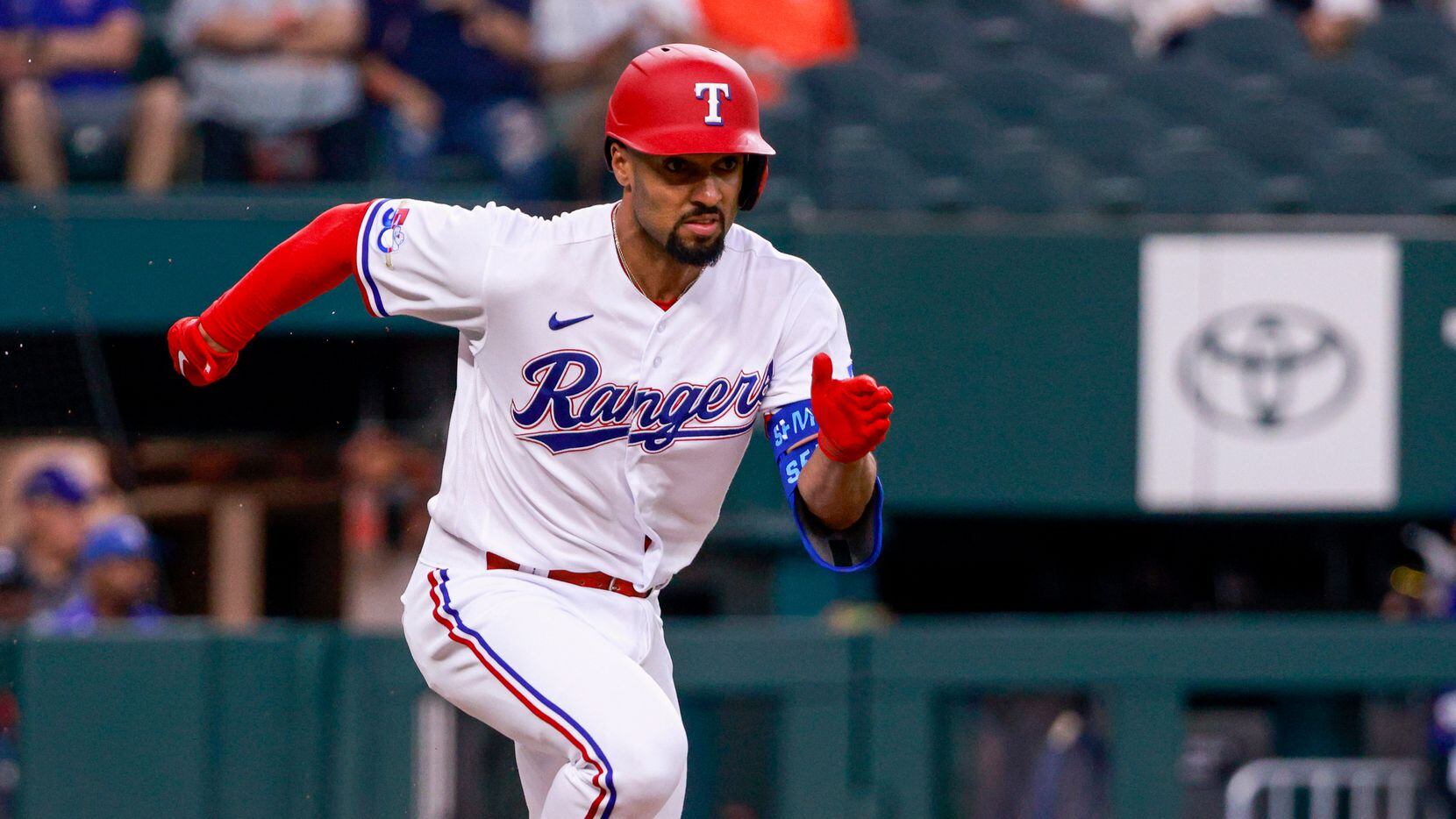 Texas Rangers second baseman Marcus Semien (2) runs towards first during the first inning...