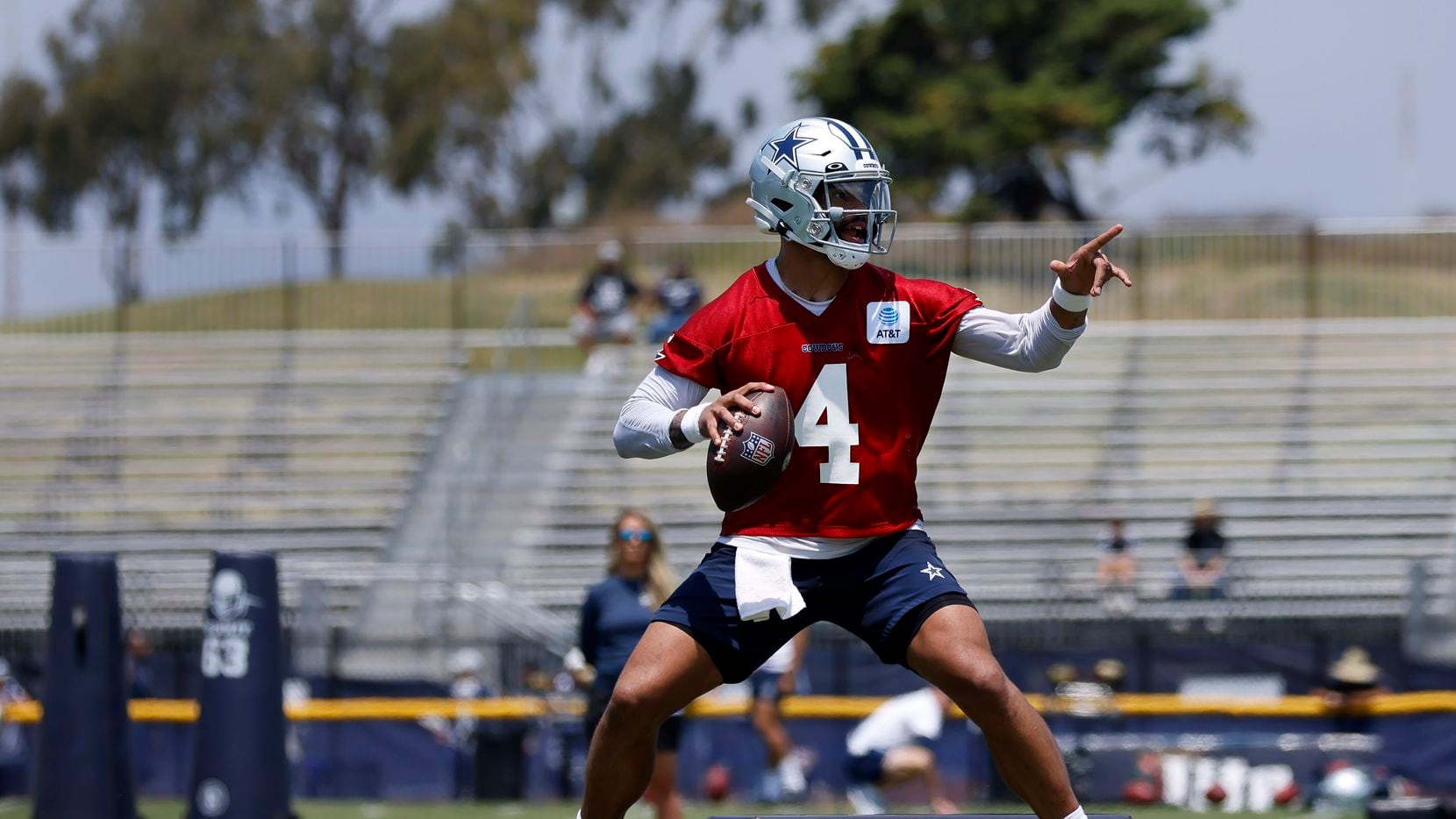 Dallas Cowboys quarterback Dak Prescott (4) points to his receiver as he negotiates the...