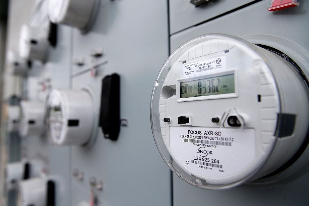 Electric meters are seen in the back of an apartment complex in Old East Dallas. Smart...