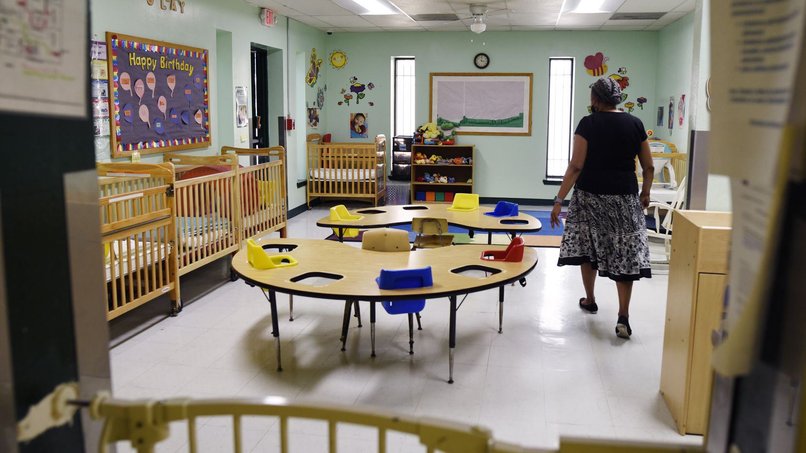 Dr. Ora Watson, owner and director of For Keeps Sake Child Care Academy, walks through an empty infant classroom at her child care academy in Dallas. On Tuesday the academy had one infant; before the pandemic the infant room catered to 10 kids a day.