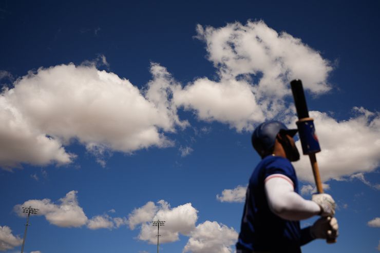 Texas Rangers' Ezequiel Duran warms up on deck during a spring training baseball game...