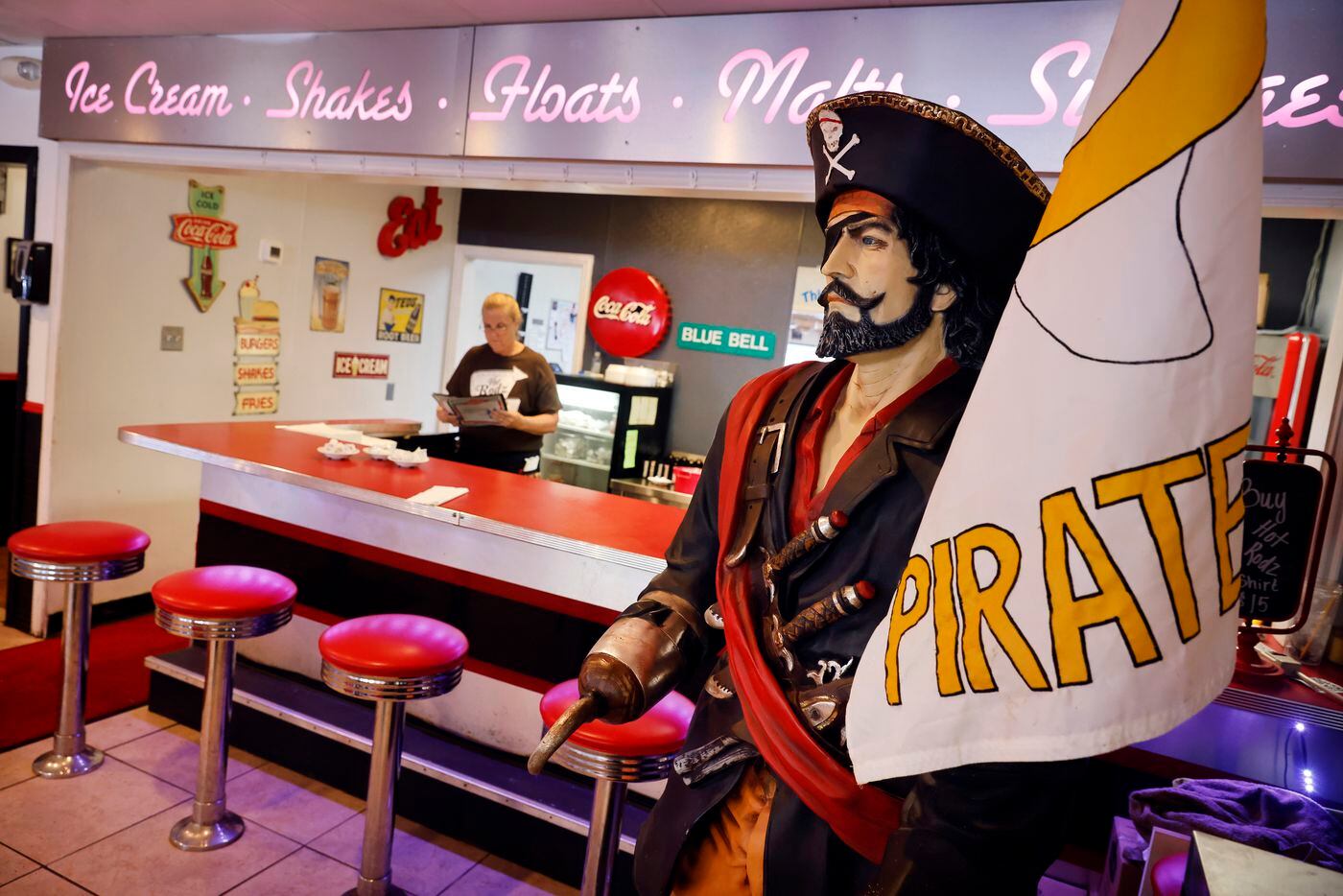 A life-size Crandall High pirate mascot stands ready for selfie photos inside the Hot Rodz...
